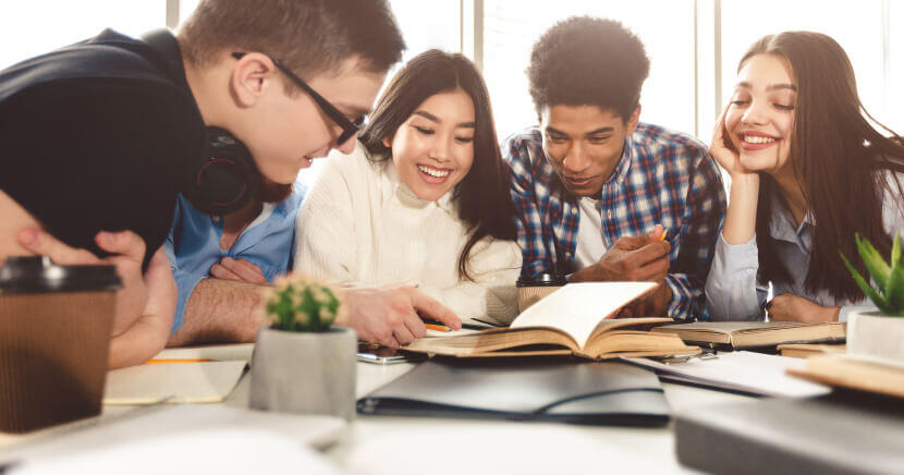 Diverse-Student-Group-Studying-At-Library