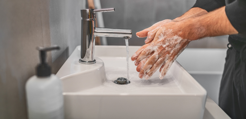 Man-washing-hands-with-soap-at-sink