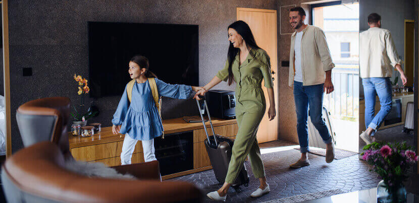 happy-family-entering-luxury-hotel-room