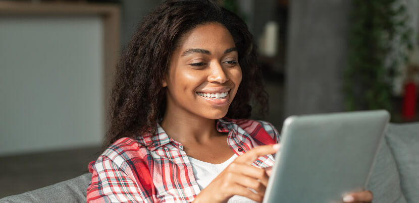 happy-young-woman-reading-pressreader-on-tablet