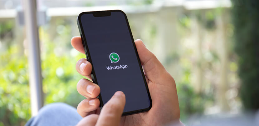 man-holding-phone-and-using-whatsapp