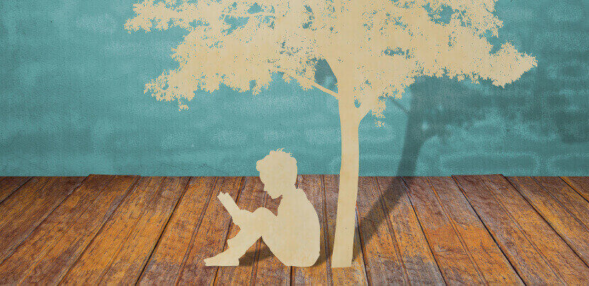 paper-cut-out-reading-under-tree