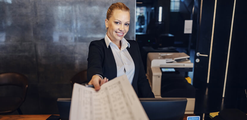 receptionist-giving-paperwork