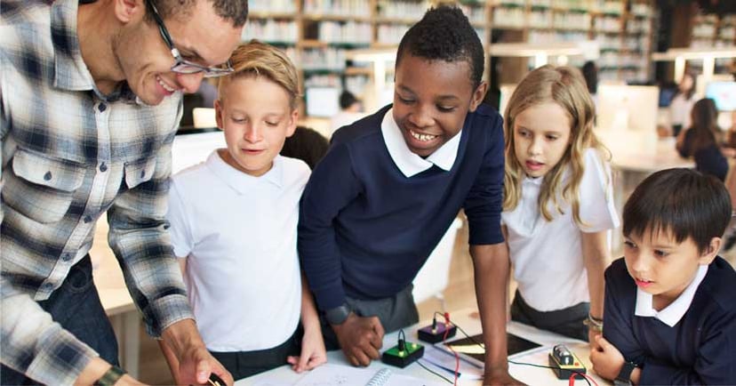 students-and-teacher-in-school-library