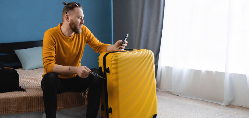 traveller-relaxing-in-hotel-room-with-suitcase