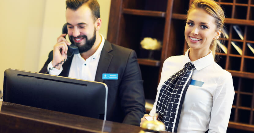 Two Hotel Receptionists At Desk ?width=1660&name=two Hotel Receptionists At Desk 
