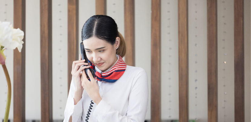 woman-concierge-in-hotel-lobby-on-phone