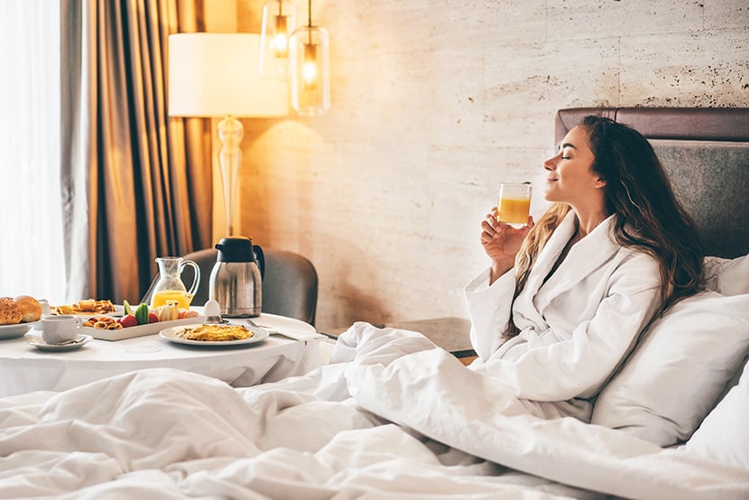 woman eating breakfast in the hotel room