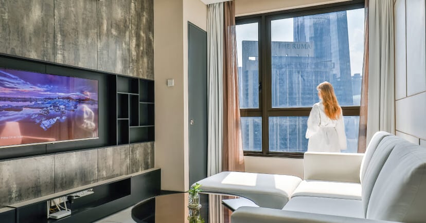 woman-enjoying-luxury-hotel-room