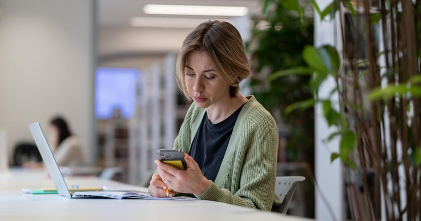 woman-in-public-library-using-tech-devices