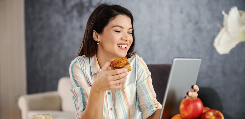 woman-reading-tablet-at-breakfast-table