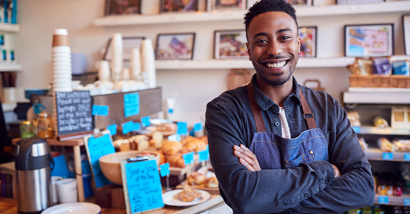 young owner stands inside his coffee shop