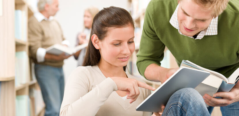 young-students-using-tablet-in-library