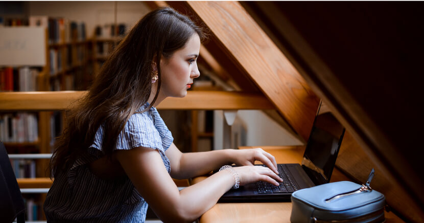 young-woman-on-laptop-in-library