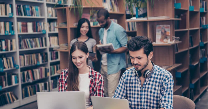 happy-students-in-busy-library